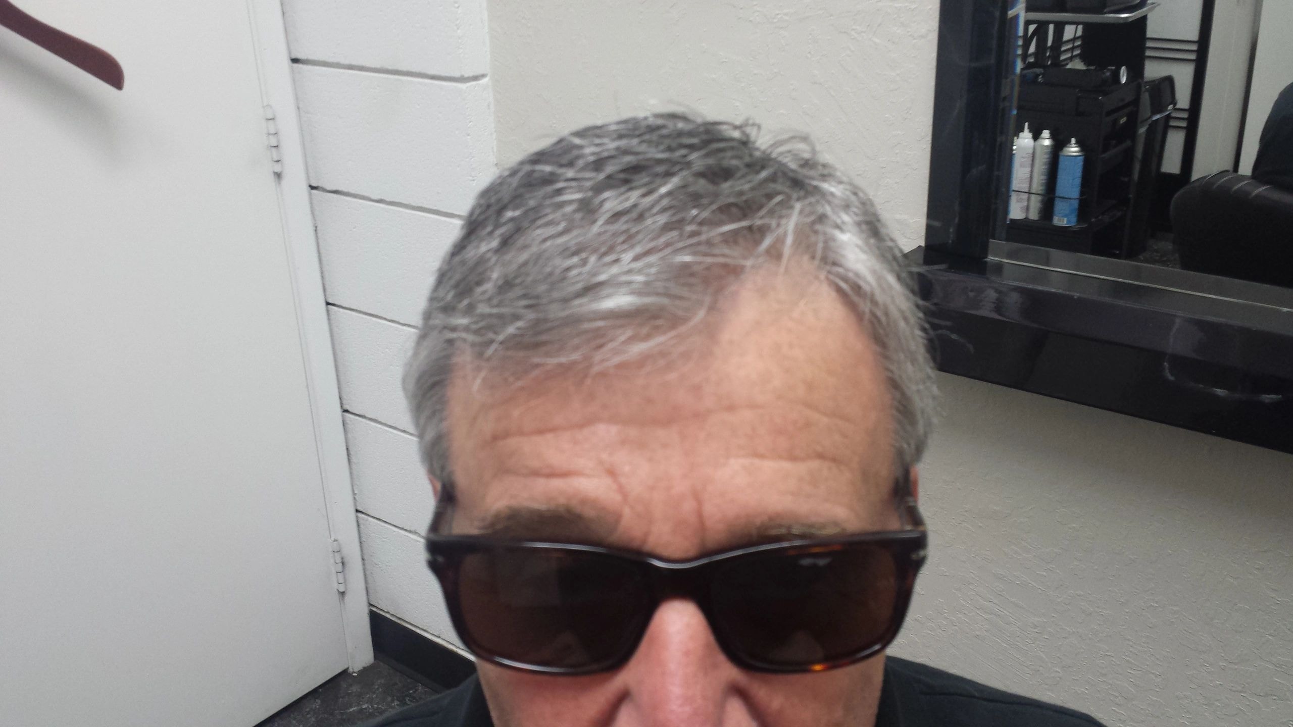 Older man with gray hair in salon